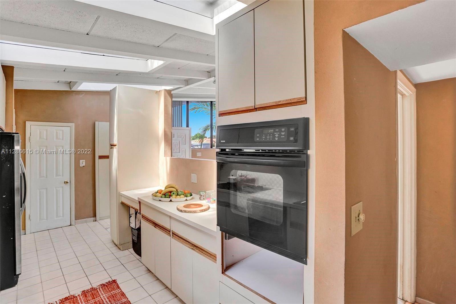 The white door leads to laundry room and third bedroom..