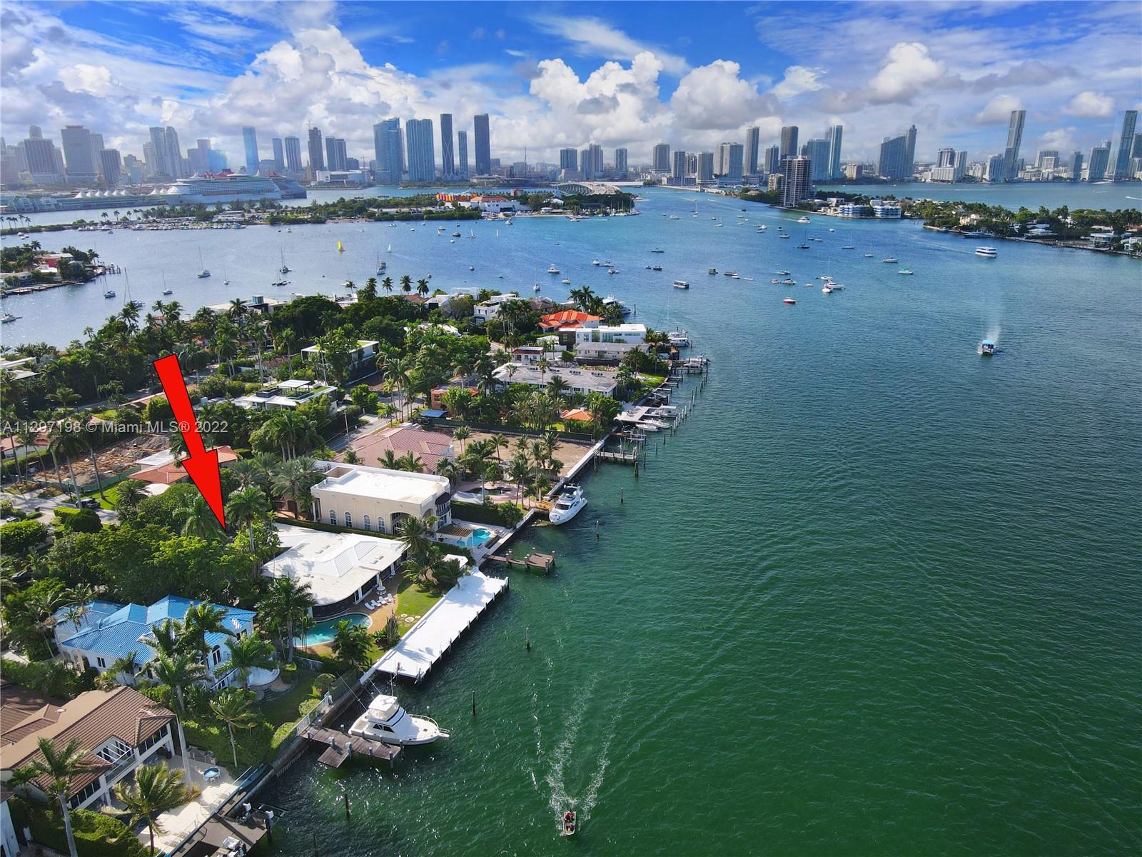 Listed for the first time in 45 years, this rare to market home is located on a 21,000 SF double lot with 120' on the wide water and a huge dock for your yacht.  Undoubtedly the best wide inter-coastal views on the islands, this house faces NE for stunning sunrises.  This double lot can be divided to build 2 new homes or build one huge dream home on the full 1/2 acre.  The home is a time capsule from the 1970's and ready to remodel or replace.  Minutes to SOBE and the beaches. This is what Miami is all about. Please do not disturb the owners.  Note developers: build two 5,000 sf homes and sell them for over a 30% profit.