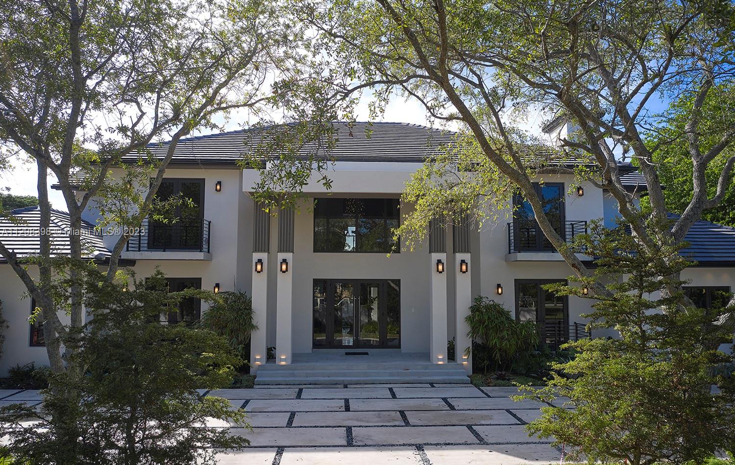 Fall in love with this new modern almost total of 9000 SF tropical residence that settles seamlessly in picturesque Pinecrest with a timeless, elegant, and comfortable spirit, muted in palette and filled with light. The glamorous estate is designed as an experience, unveiled in sequence: dramatic foyer, formal architectural dining room, modernist living areas, Fendi-inspired kitchen, home theater, private spaces, and separate service area with maid-quarters. The lush landscape is on full display from glass lined terrace and cabana with a summer kitchen around a resort-style pool. Living is an emotion, and how you want to feel is reflected in every aspect of this designer home. Pinecrest is filled with lush greenery, renowned bike trails, top schools, and large estate homes.