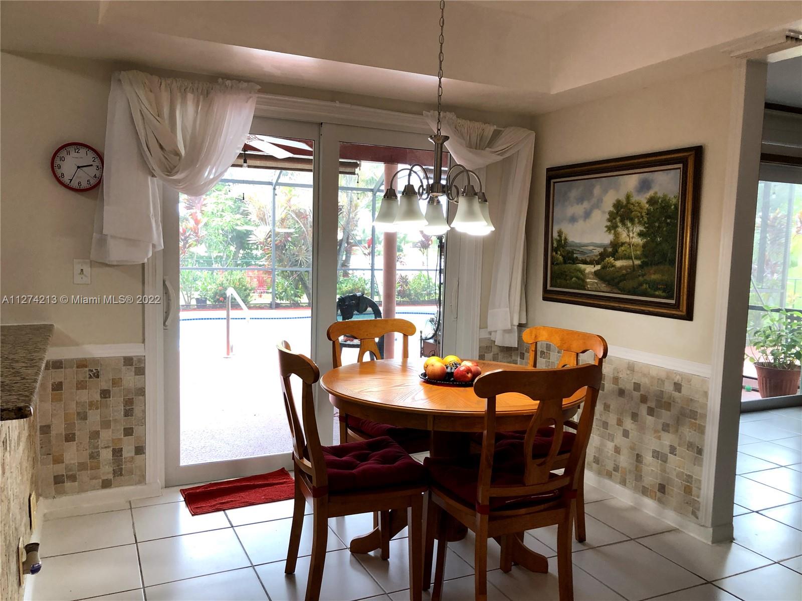 Bright and sunny Eat in Kitchen area overlooking pool and lake!