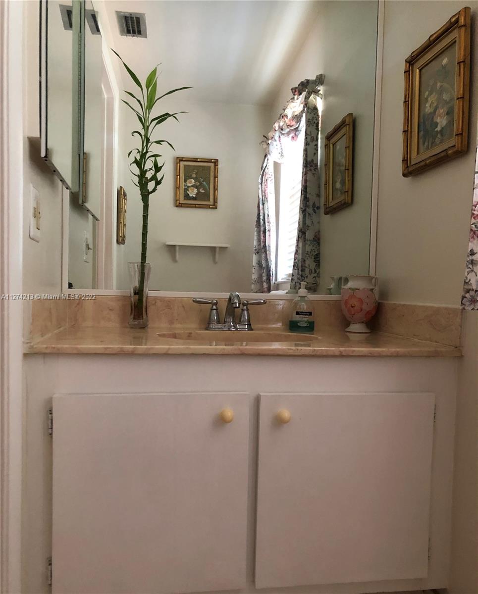 Half bath 1st Floor with mirror medicine cabinet and updated fixtures.