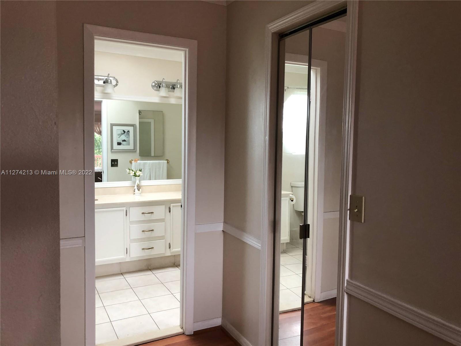 Foyer to Masterbath. Mirror bifold on each walk in closet.