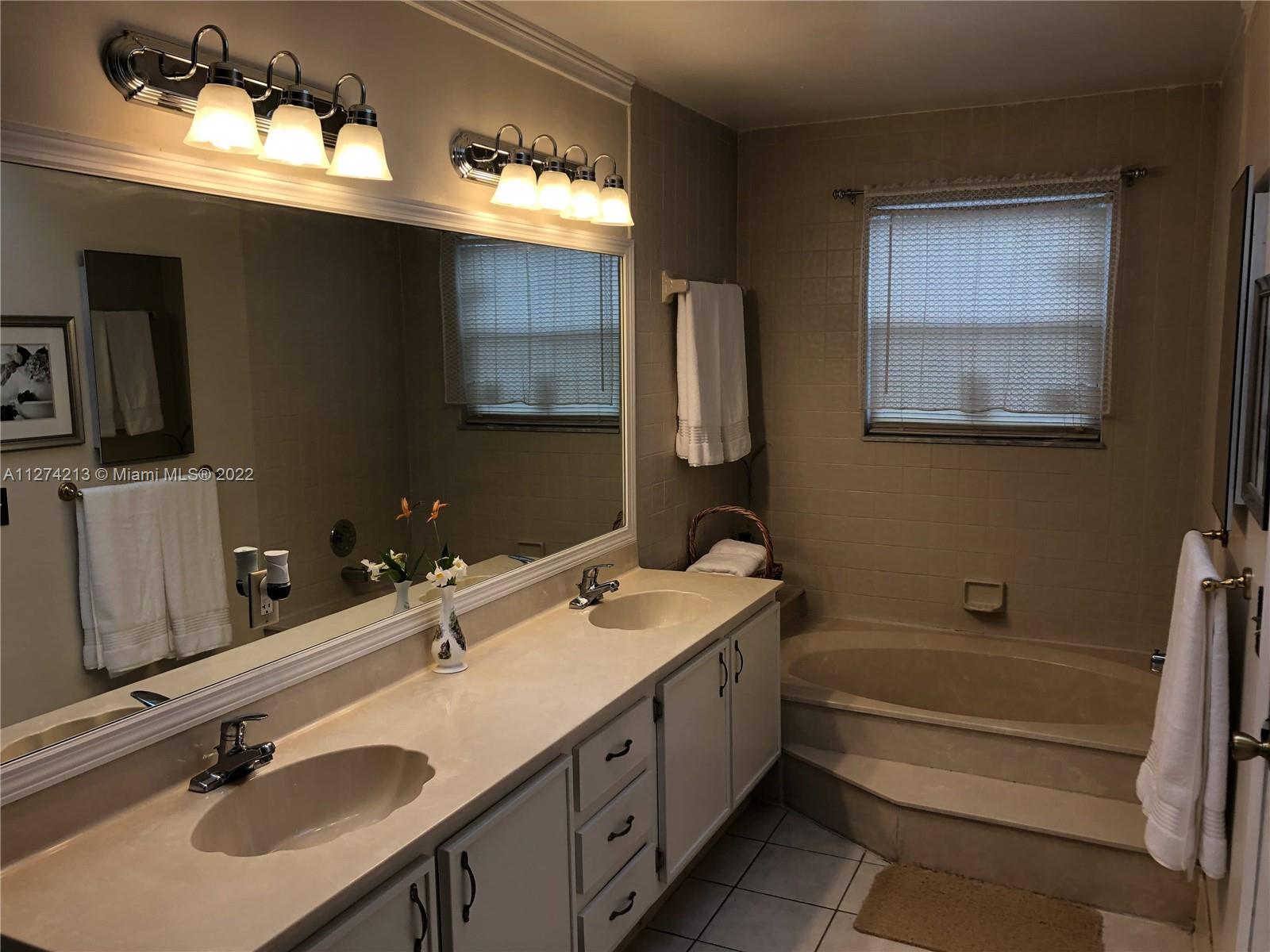 Update Masterbath with new lighting fixtures, tile floors, dual sink, Roman tub, and separate shower.