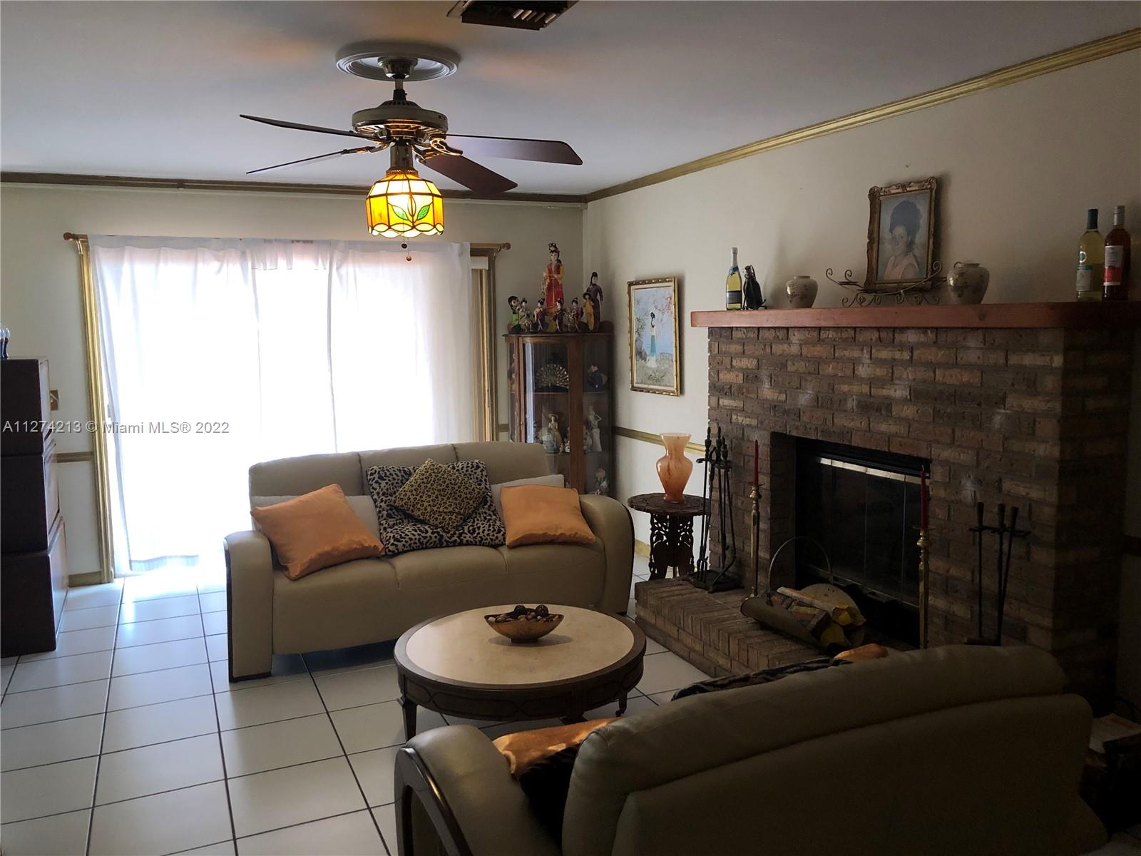 You will love the large Family Room with ceiling fan, cozy Brick Fireplace, ceramic tiles throughout, molding throughout room, and spectacular view of the pool and lake.