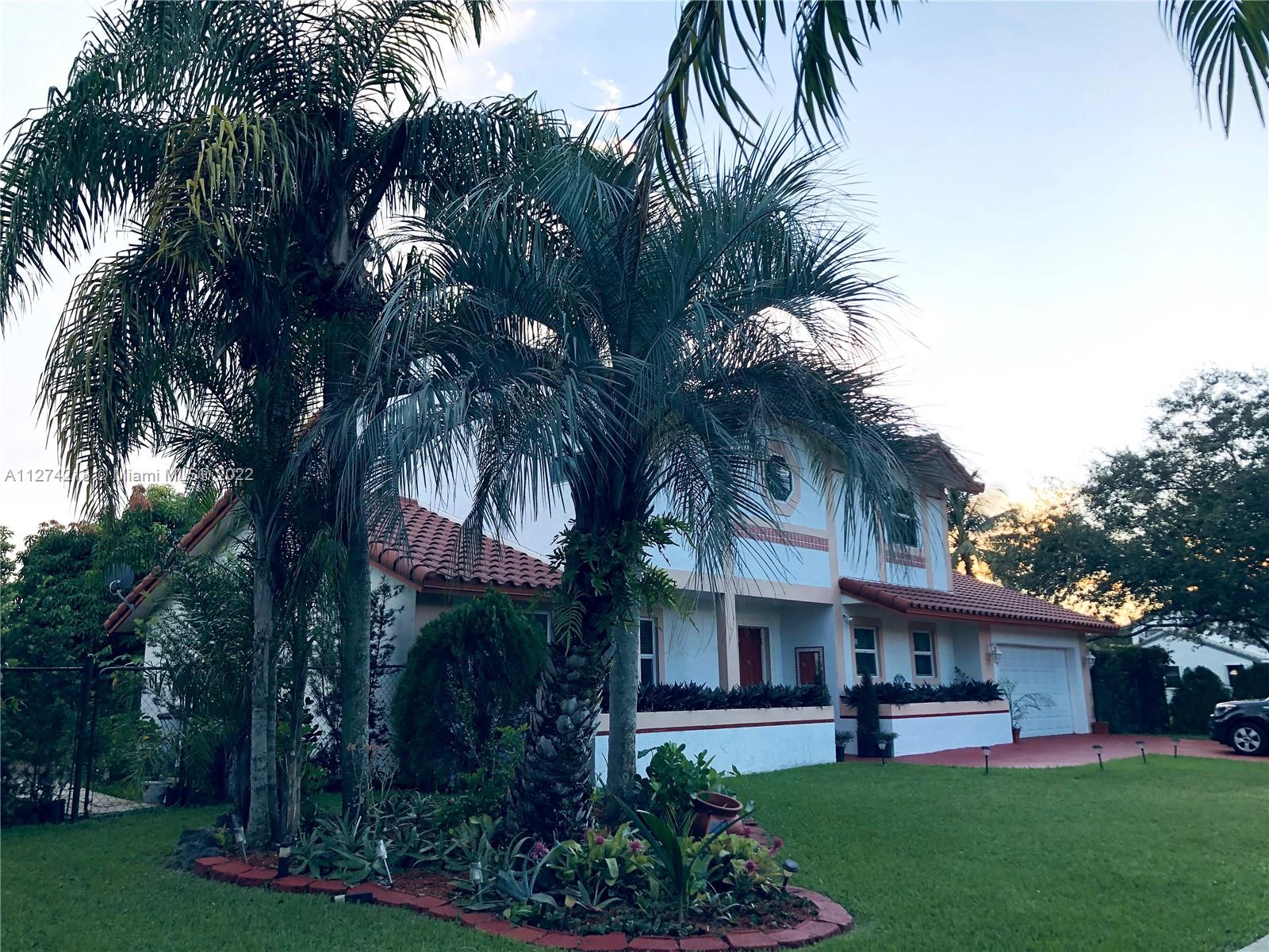 Side view of the house, gated. Walk way to garden.