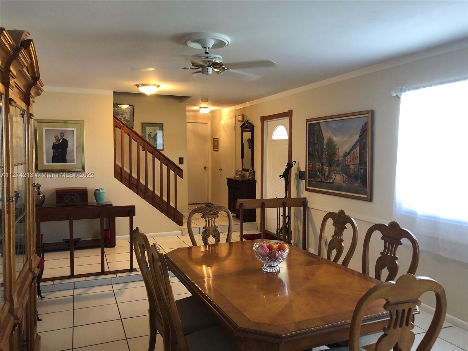 Large and bright Livingroom (currently being used as formal dining room), with ceiling fans and molding throughout. Great for entertaining!