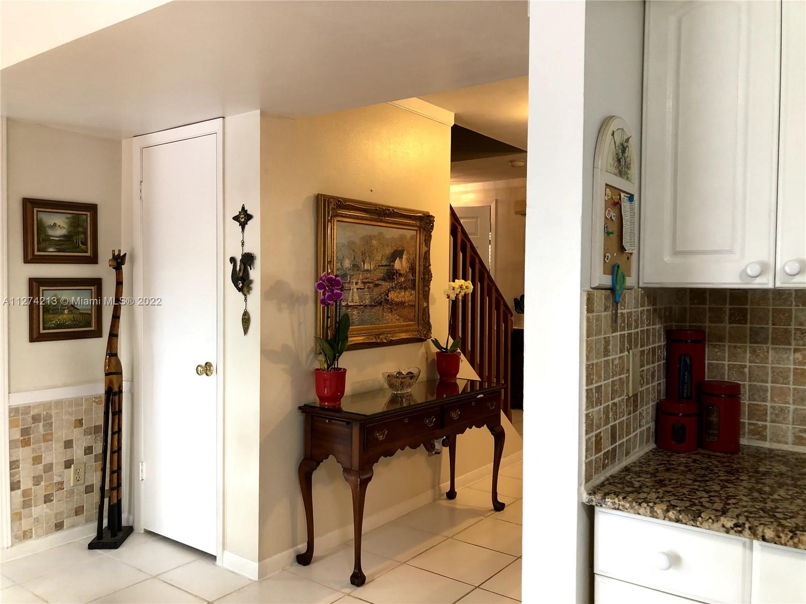 Foyer lead to Eat in Kitchen Area and large closet (extra pantry) underneath staircase.