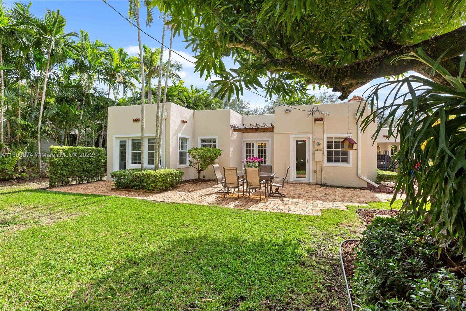 Charm and beauty reside on Alesio Avenue. Sunlight pours into this beautiful home, just blocks from all that downtown Coral Gables has to offer shopping, restaurants & culture. The property features a 3/2 main house with a detached 1/1 cottage. Great layout, fireplace, and arched transitions complement modern enhancements like new A/C, impact windows, and updated kitchen and bathrooms. It has room for a pool, has a large foyer and fruit trees. The updated kitchen has a built-in Breakfast nook with views of the yard.
The professionally landscaped yard includes a Chicago Brick patio, driveway, and carport. This Old Spanish charmer will have you at “Hello!”