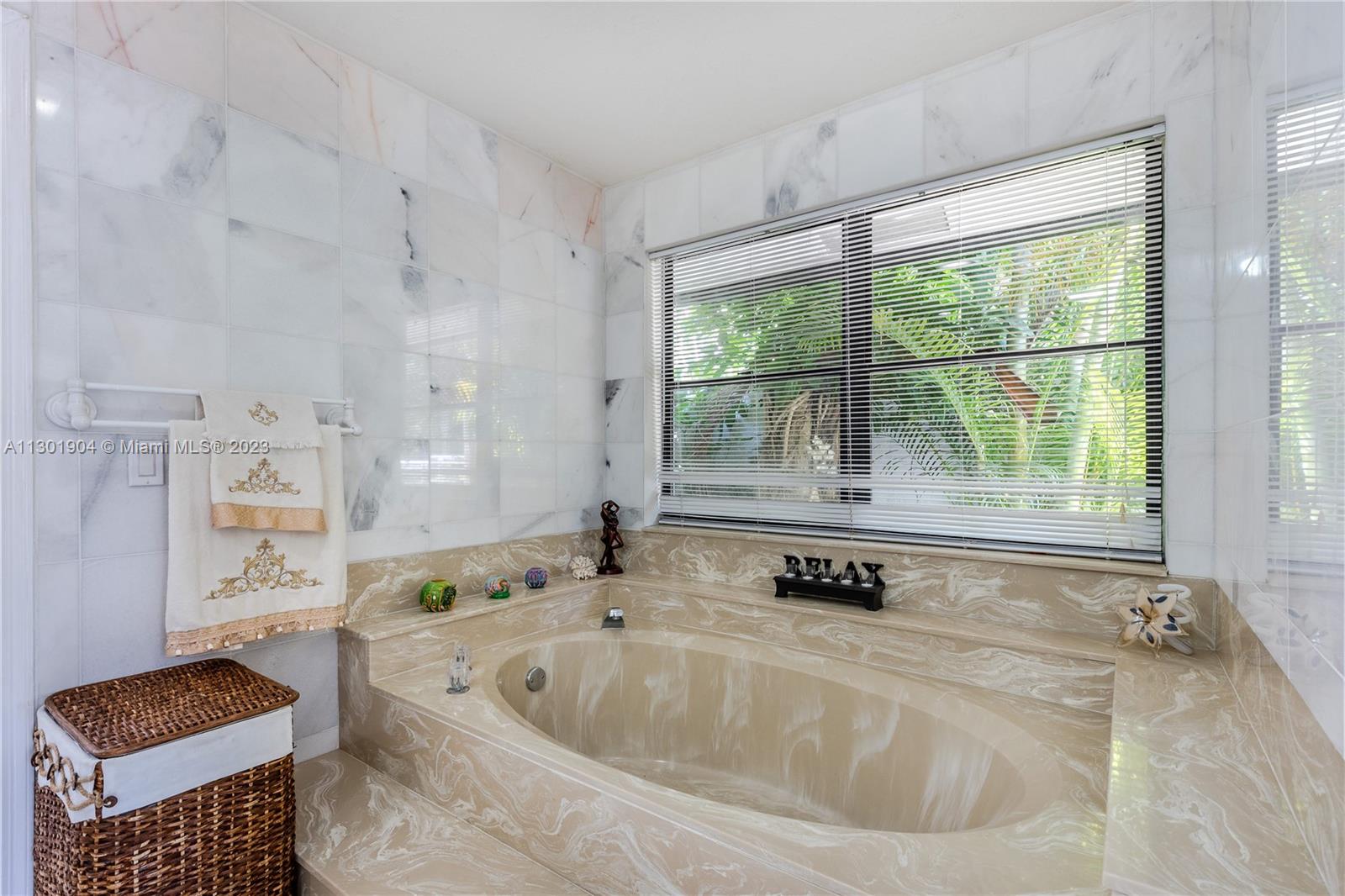 Independent White Marble Shower with pebble floor and beautiful finishes