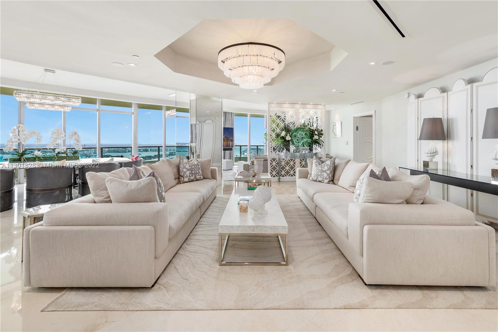 IMPECCABLY DESIGNED AMBIENT-STYLE PENTHOUSE WITH PANORAMIC UNOBSTRUCTED BAY & OCEAN VIEWS! Gut-Renovated Masterpiece w/ $1.5 Million in Renovations & 36x36 Marble Flooring t/o. 3,793 SF of Interior Living Space + 991 SF Terraces w/ 3 BR w/ Smart Beds + Cinema/Media Room + 3.5 Baths. Elegant Integrated Living & Dining & Work Area Ideal for Entertaining. Wrap-Around Balconies (270°). Italian Chef's Eat-in Kitchen by Aran Cucina. Custom-Made Design Furniture. Spacious Primary Suite w/ Direct Bay Views & Primary Bath Sanctuary Adorned w/ Exquisite Tiling + Steam Room + Jetted Tub. Full-Service Building w/ Architecture by Luis Revulta & Amenities by Sam Robin Interiors with Recently Completed Full Façade Renovation. Minutes from South Beach, Museums, MIA, Brickell, Wynwood & Design District.