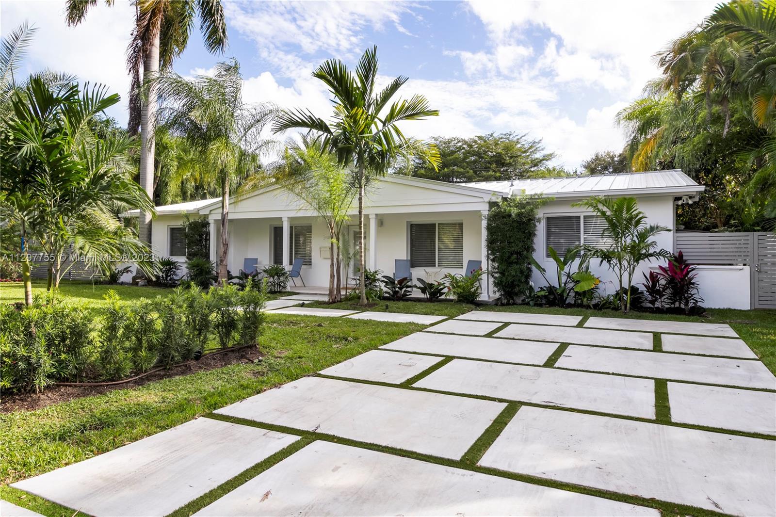 Gorgeous fully remodeled house in sought after South Miami, 4 bedrooms, 3 bathrooms, new metal roof, impact windows, concrete slab driveway and beautifully remodeled kitchen.  Enjoy sitting outside under a large covered terrace overlooking the pool and tropical landscaping.  Walk to Dante Fascell Park and Sunset Shops and restaurants. Move in ready.