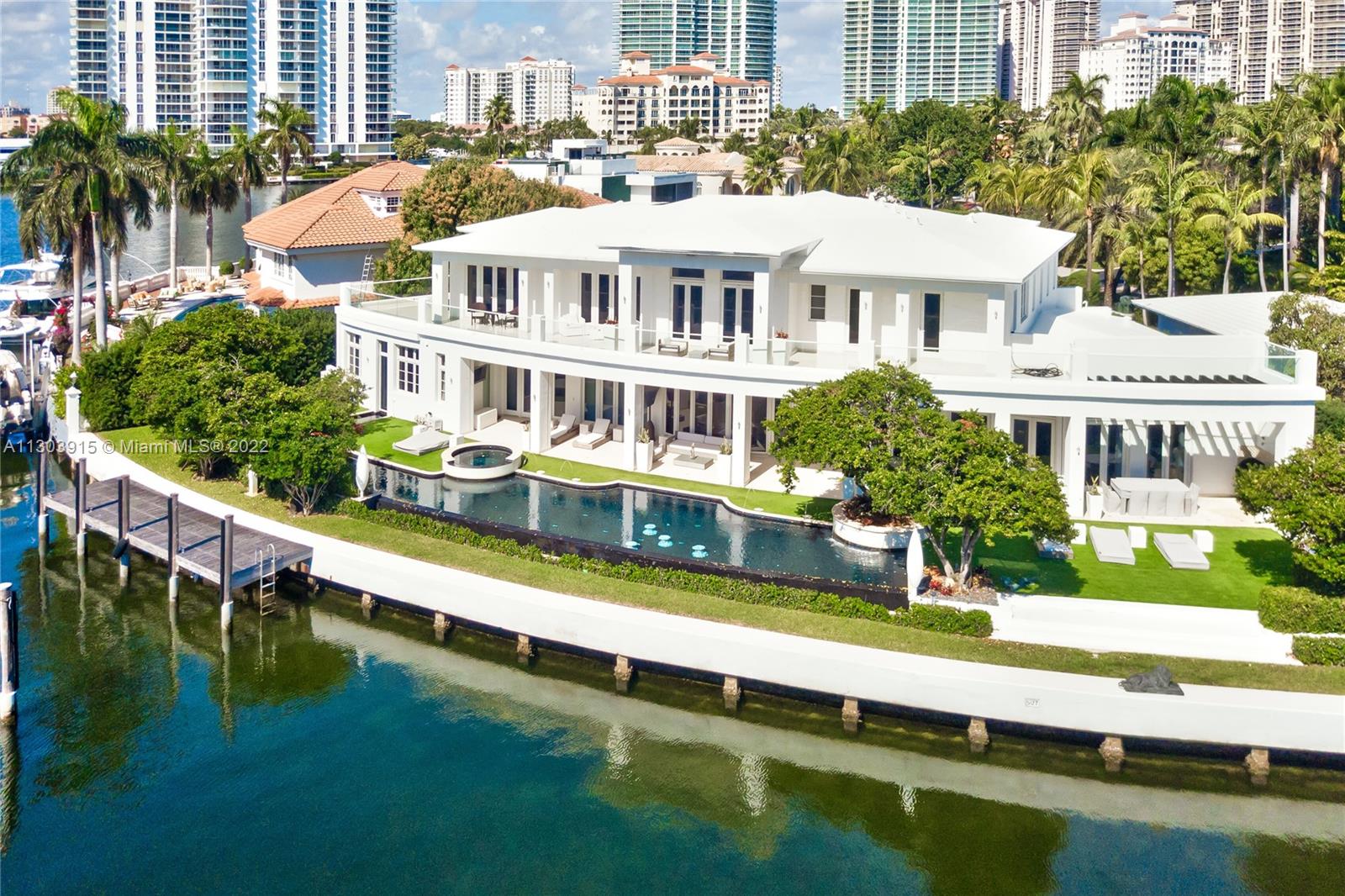 Magnificent Golden Beach waterfront estate, with 188 ft of prime water frontage, on the LARGE Southern canal of Golden Beach. This impeccable residence offers panoramic private views, fabulous resort-like amenities and beautiful landscape. Full gym and spa, 100 ft infinity edge pool, theater, elevator, wine cellar. Expansive master suite with his and her baths, oversized rooms, office, high ceilings, window treatments and outstanding finishes. Boater's paradise, with 60' dock. Total covered area 11,337 sf and air conditioned area 8,738 sf.