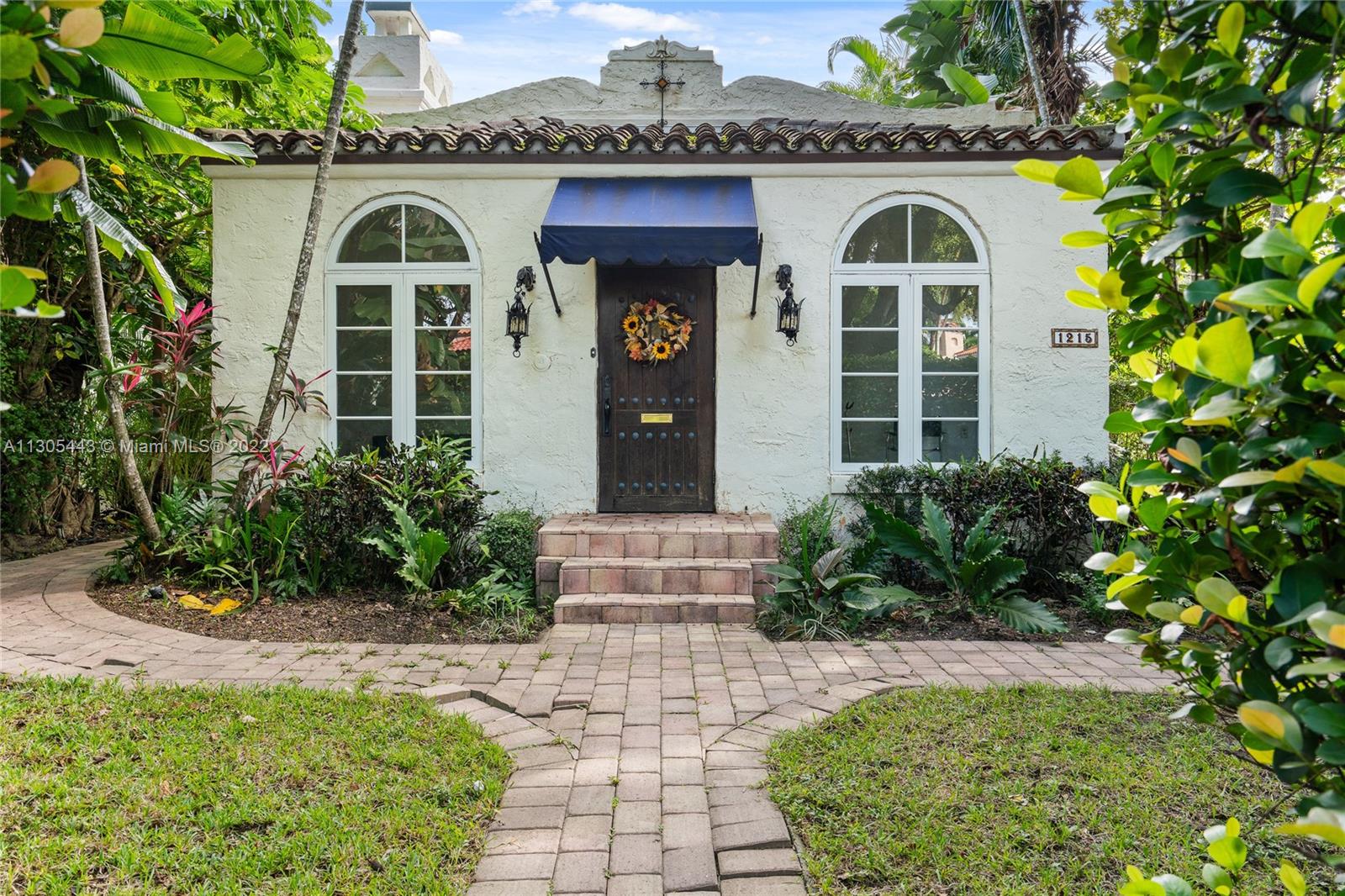 Beautiful Old Spanish home on a corner lot in Coral Gables. Impact Glass windows all over, 2 car garage.Spacious sun room upon entering that has high ceilings.Mosaic tile floors,charming fireplace in living room,large bright windows,hardwood floors,spacious main bedroom suite has a large walk in closet and main full bathroom,large living room and spacious informal dining room.Nice and bright kitchen,granite countertops,marble backsplash,wood chop block, and skylight.
Detached 3rd bedroom on second floor, carriage house style.It has lots of light,full bathroom,kitchenette and walk in closet. Enjoy beautiful mature trees and plants giving lots of privacy and  quite street. Brick paver walking path surrounds the outside. Newer AC. 2/2 main house plus detached 1/1 on the second floor.