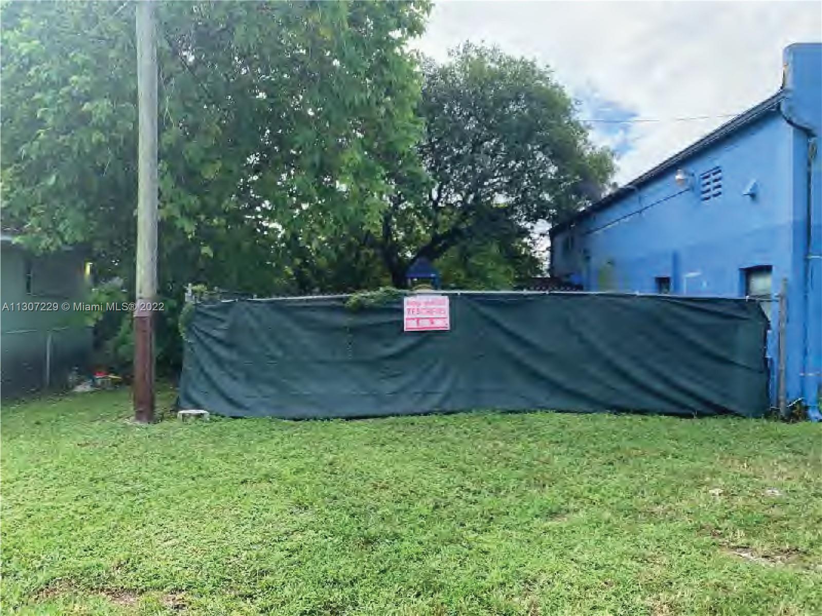 View from the North side City-owned Lot to the Gated Children's Play Area behind the 3,000 SF Main Building