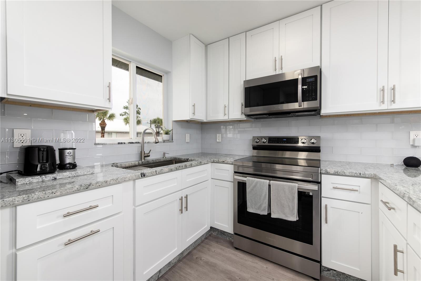 The kitchen cabinets and stove/microwave.