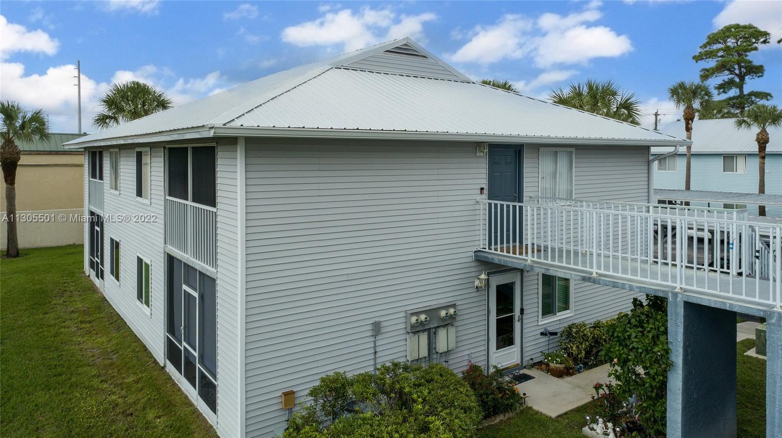 Aerial view of the left side of the unit showing the doorway and the balcony.