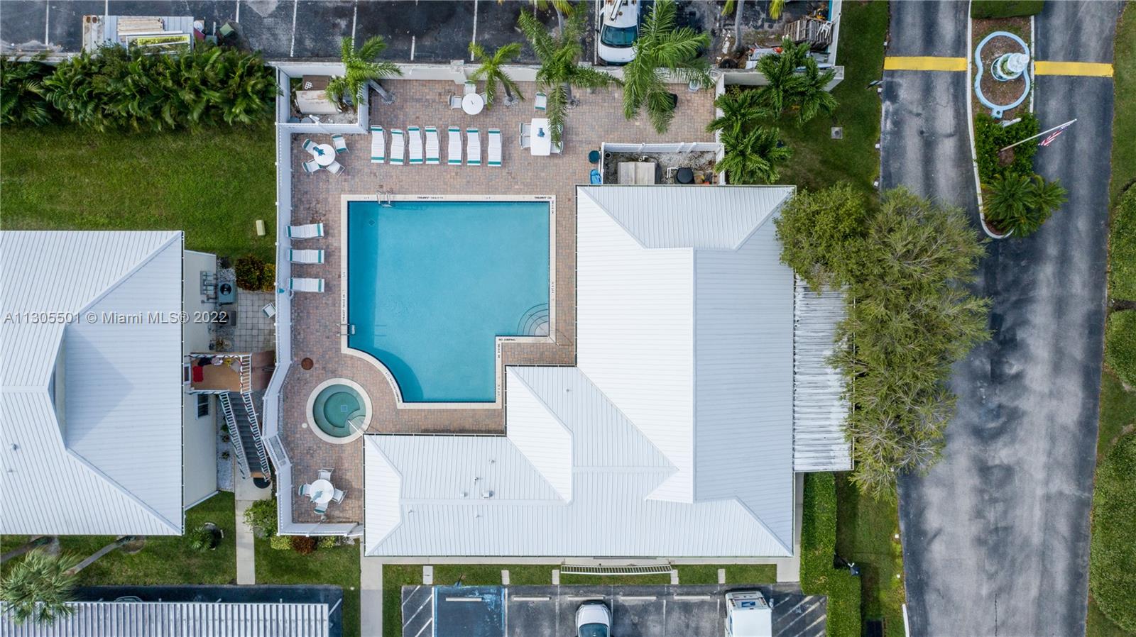 Top down aerial view of the clubhouse and the pool area.