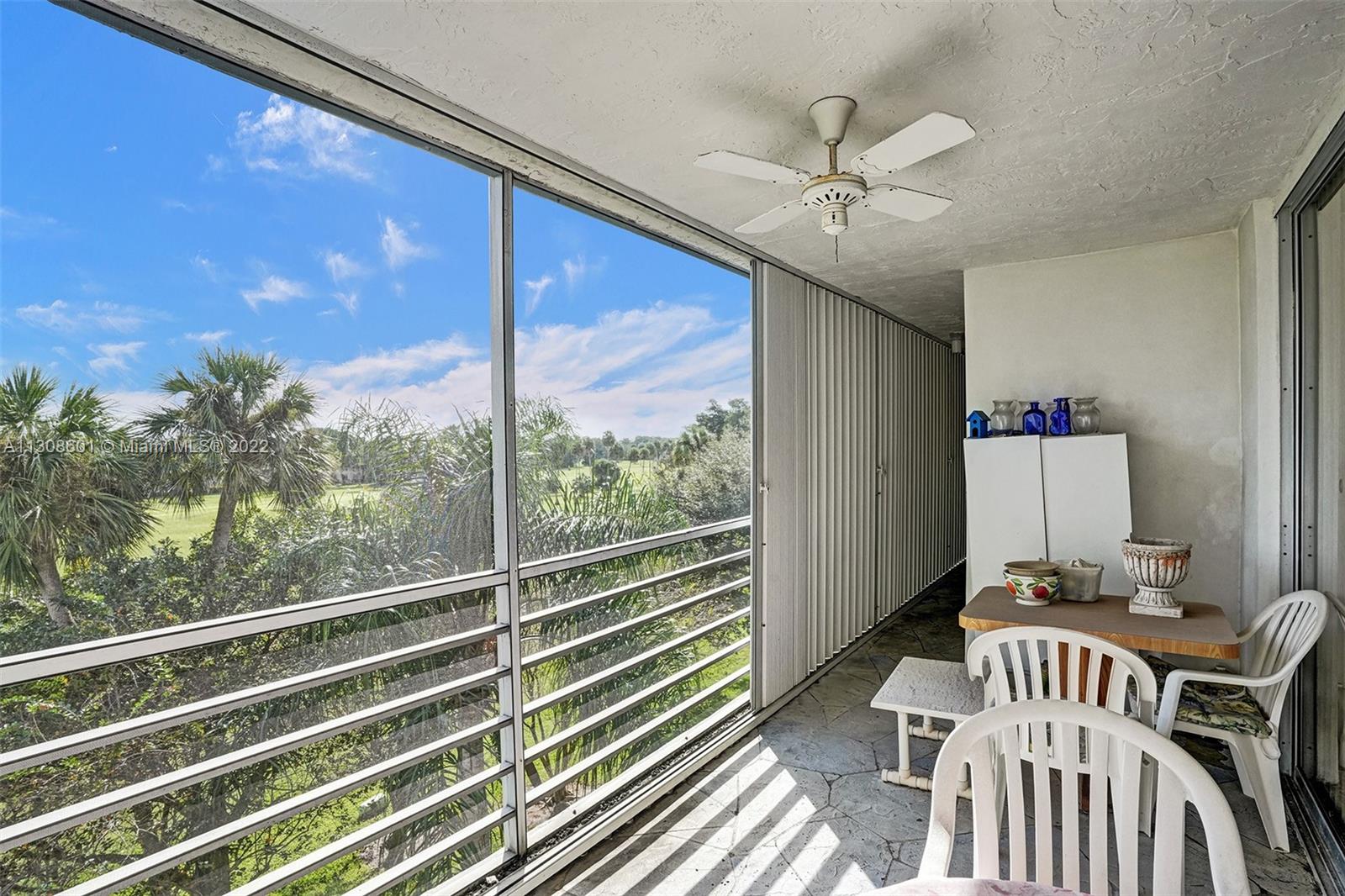 SCREENED BALCONY OVERLOOKING THE GOLF COURSE WITH ACCORDIAN SHUTTERS