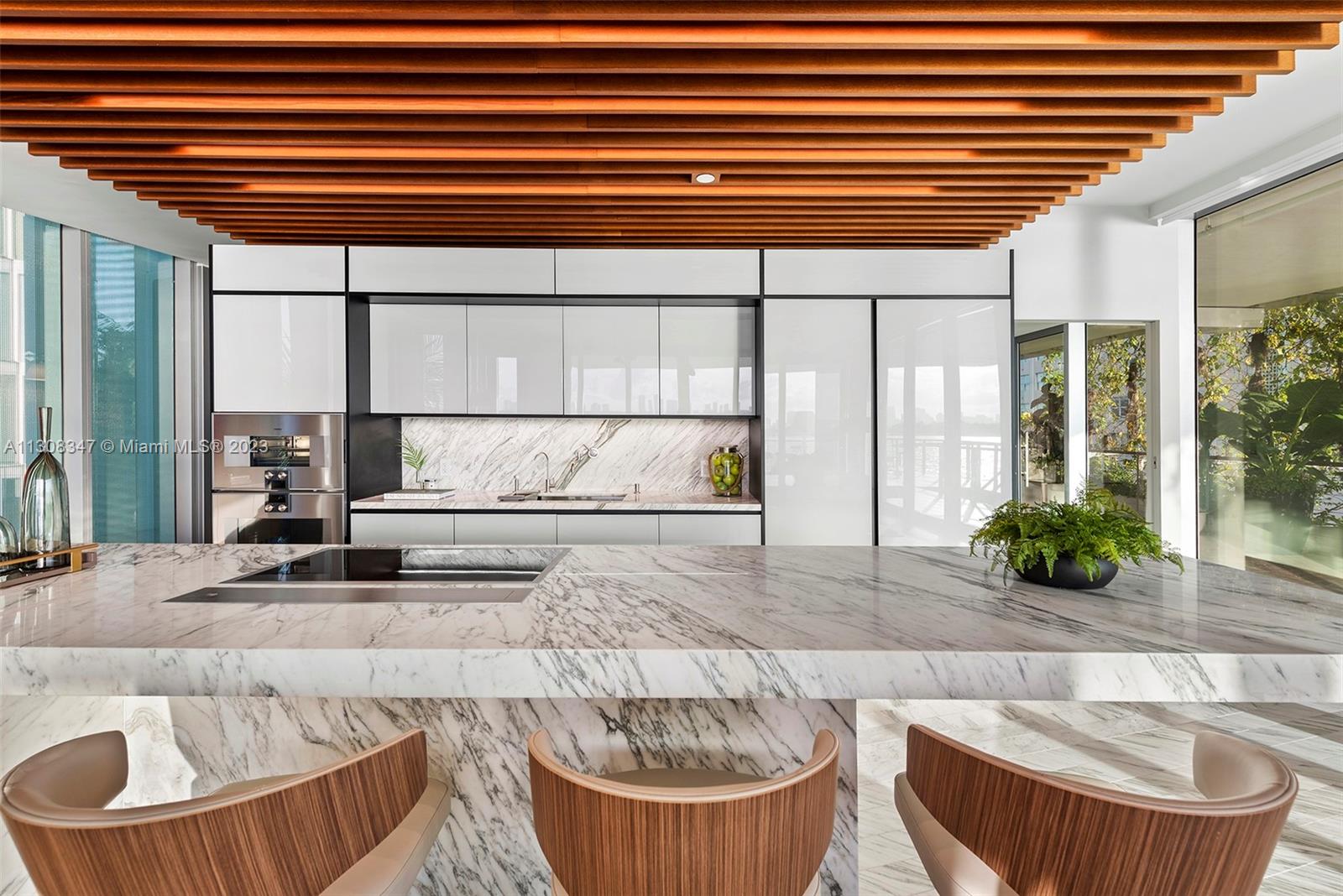 An incredible residence conceived by Priztker Prize Architect Jean Nouvel in Miami Beach's premier bayfront. The iconic architecture blends within the natural habitat landscape featuring a lagoon surrounded by climbing gardens leading to the wide-open Biscayne Bay and Miami skyline sunsets. 2F is the only premium sized 3bedroom available and includes a jaw-dropping 3,200 SF terrace comprising 5,840 total living SF. A private staircase leads to an Ipe wood terrace and jacuzzi, sun lounges and 113’ pool. Enjoy serene evenings enhanced by your own illuminated bay-liner reflecting pool on your terrace. The primary suite features Poliform closets, richly veined marble baths and floating tub. Kitchen boasts a carved Calacatta marble island, Gaggneau, back-lit louvers and Poliform cabinets.
