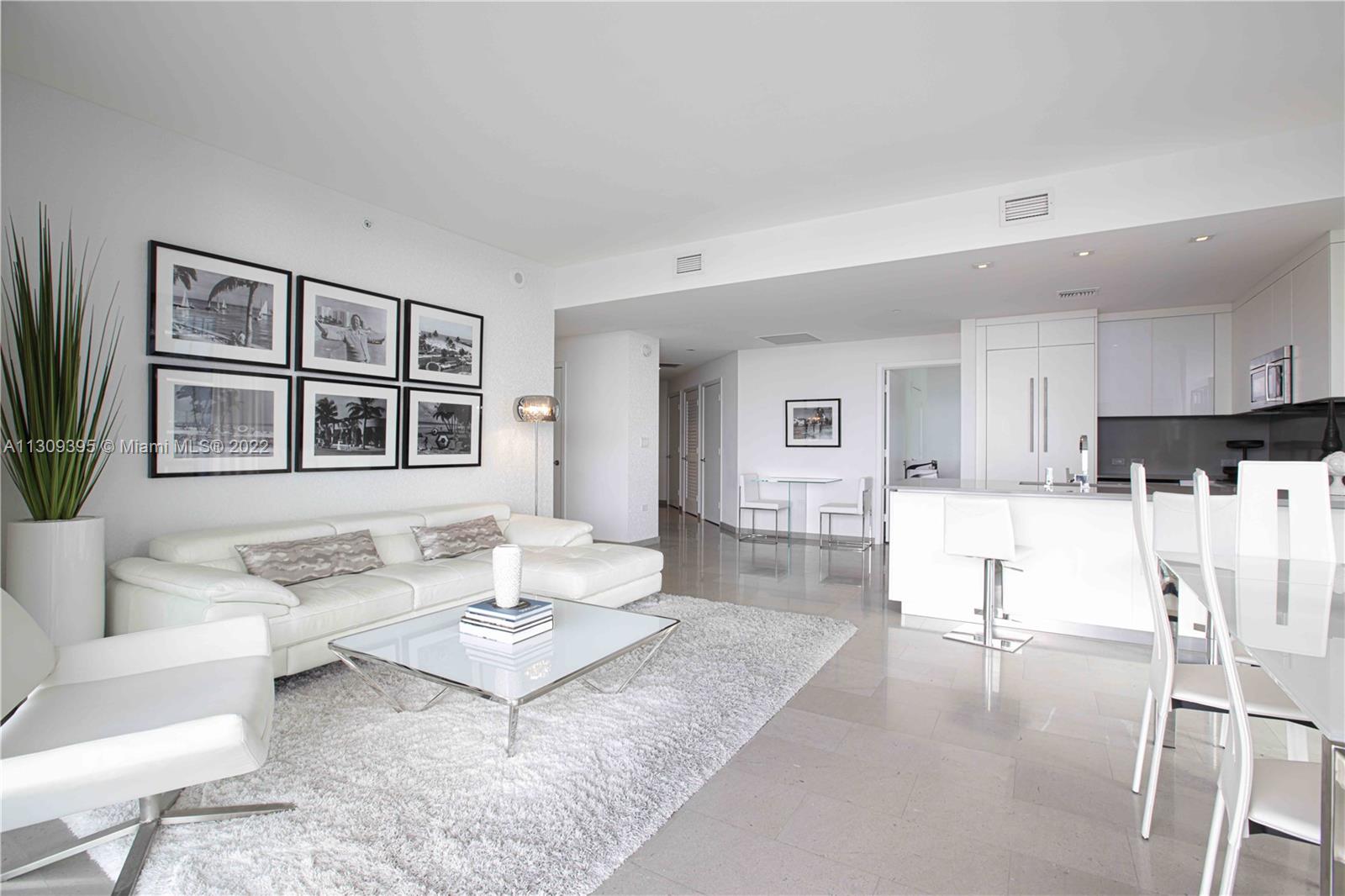 The ultimate luxury living, step into a modern welcoming foyer leading you into an open concept corner unit with floor to ceiling impact windows facing southwest views w/ a slight east view.The ultra sleek kitchen is fully equipped w/ a monochromatic concept, Italian Bosch appliances & wine cooler. All day natural light throughout 3/3.5 vertical home with the most spectacular sunset views. The dining/living space is equipped w/ electrical window treatments. Enjoy an indoor-outdoor living concept w/ multi sliding doors. Closets are finished with custom cabinetry. Master bedroom is complemented w/ a lush bathroom finished with natural tones, vanity w/ double sinks,large standing shower,soaking bathtub,smart toilet. BCC Rise offers full luxury amenities with privacy and security.