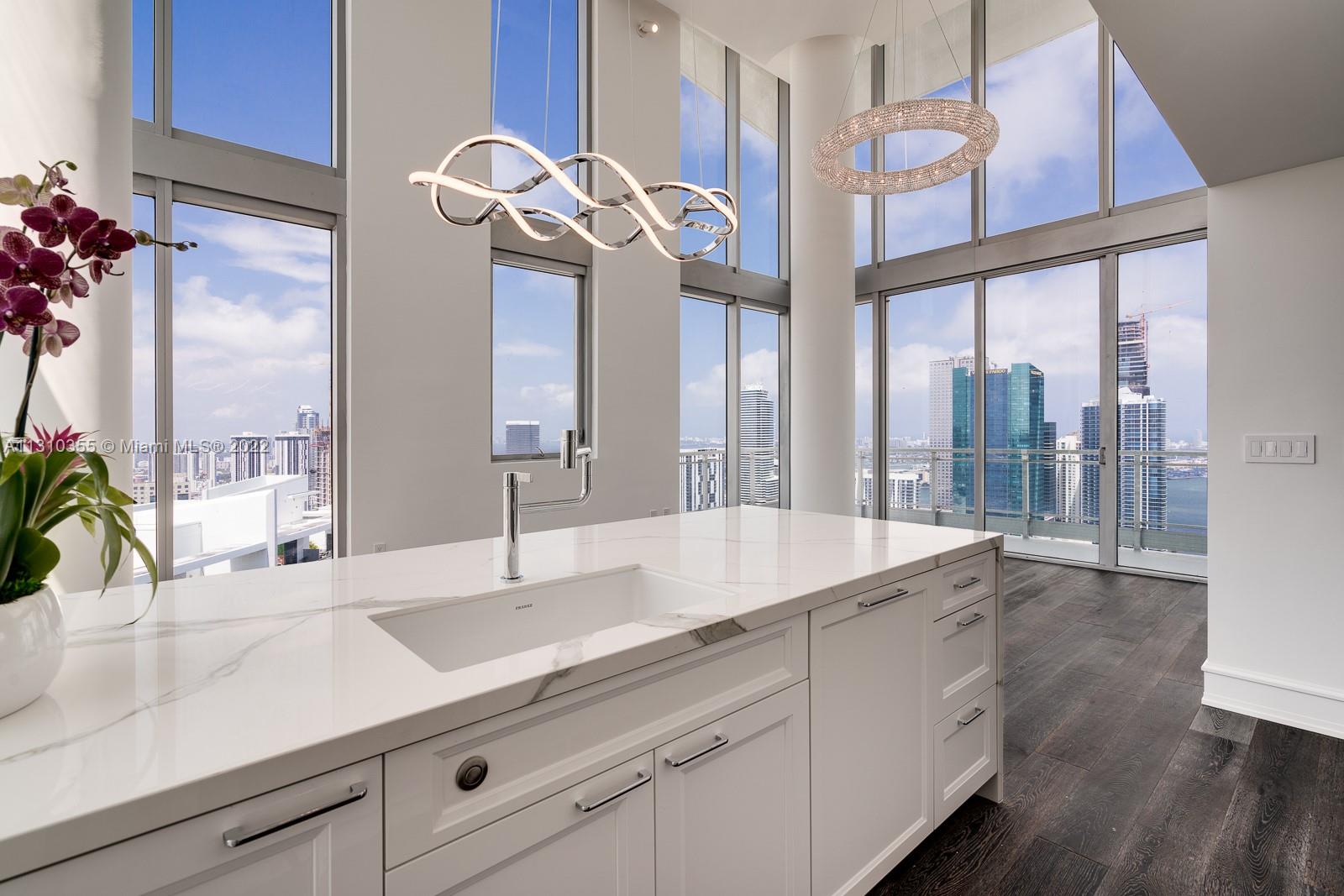 Re-priced at APPRAISED value! Jaw-dropping, fully customized & BRAND NEW PH @ Mint: No detail has been overlooked in this top floor 3 bed w/double-height ceilings & 3 view exposures - 270+ degrees of ever-changing skyline, water, and sunset + sunrise views. Hardwood floors, electronic retracting light fixtures, imported cabinetry w/integrated Bosch & Miele appliances, Franke kitchen fixtures, calcutta book-matched marble bath, designer bath vanities and fixtures, designer baseboards, linear diffusers throughout, 2 dual-cycle Miele washer/dryers, LG Steam Closet, custom doors & hardware, multi-color LED lighting. New Bosch AC system, new plumbing. XL storage room inside unit. 26 impact windows in living area for ultimate entertaining. Waterfront, gated complex; quick walk into Brickell.