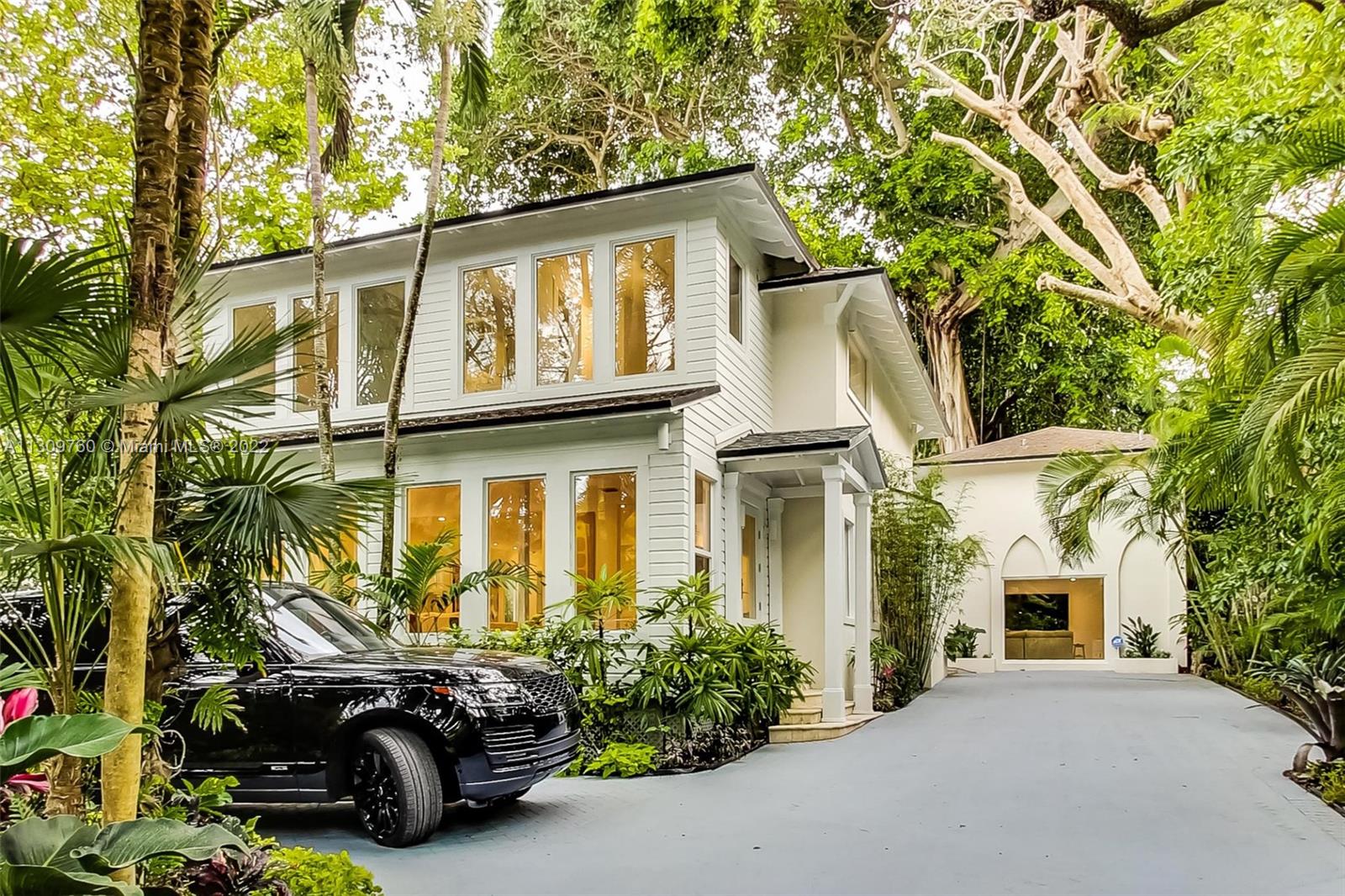 Welcome to this charming, 4 bed, 5 full bath, and 1 half-bath residence located in Southwest Coconut Grove. Originally built in 1915 and completely renovated in 2021, this home honors its original appeal while bringing in a modern twist. Upon entering, residents will find a bright and modern open floor plan, detailed with warm wood floors throughout. It features a large living space and a sitting room with direct entry to a dining room and a gourmet, eat-in kitchen complete with a peninsula, island, and Miele appliances. Each room brings the beauty of the outdoors inside, ensconced by a parade of windows that flaunt the surrounding envy-hued landscape. A second living space offers access to a beautiful backyard, featuring a swimming pool and jacuzzi.