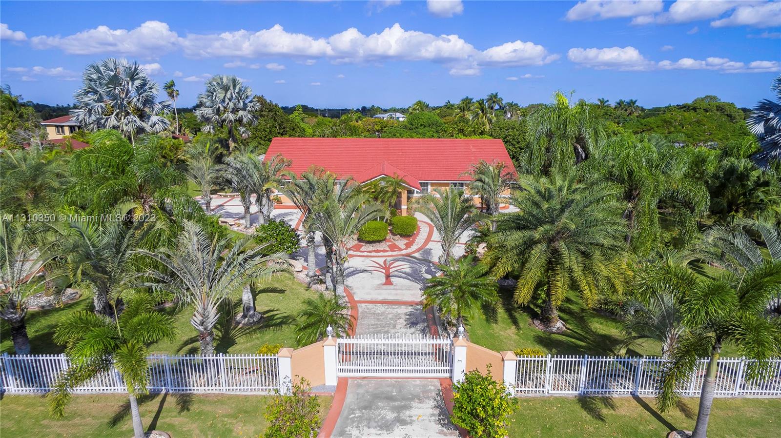 Welcome home! This 5-bedroom 3 bath home boasts pride of ownership. When you walk in you will be greeted by the volume ceilings, large formal living and dining room. Next enter the oversized kitchen featuring wood cabinets and granite counter tops perfect for entertainment open to the large family room. French doors lead to a massive porch which can close or open to allow fresh air! All bedrooms are large and offer plenty of closet space. The 5th bedroom currently functions as a media room. Pull up to your private, gated oasis sitting on over an acre of land with multiple fruit trees including 32 leech, 3 mango, 4 mamey, avocado and more! Gorgeous curb appeal as you enter the circle drive with additional parking. All accordion shutters and hurricane impact garage door. Truly a must see!