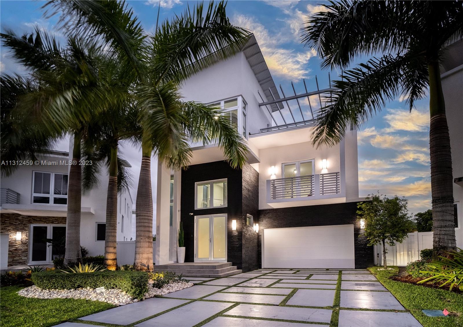 The largest home/lot in the most desirable gated community in Doral,Oasis Park, Where you can take a walk to the adjacent CityPlace Doral filled with dining and entertainment. The 3 level home has a beautiful marble staircase, or you can take the ultra modern glass elevator to access 5 bedroom, 6.5 bathrooms. New roof as of 2022, Chef's dream with a total of 3 kitchens. Resort style patio on double wide lot with a massive pergola, pool and covered summer kitchen. Expansive rooftop with kitchen,jacuzzi and area to entertain! Additional:wine cellar, office, impact windows/doors, and 2 car garage and full equipped gym inside. This is an amazing property for investors too as property can rent between 15k - 18k month, yielding a very high rental return. Home has fully water filtration system!!