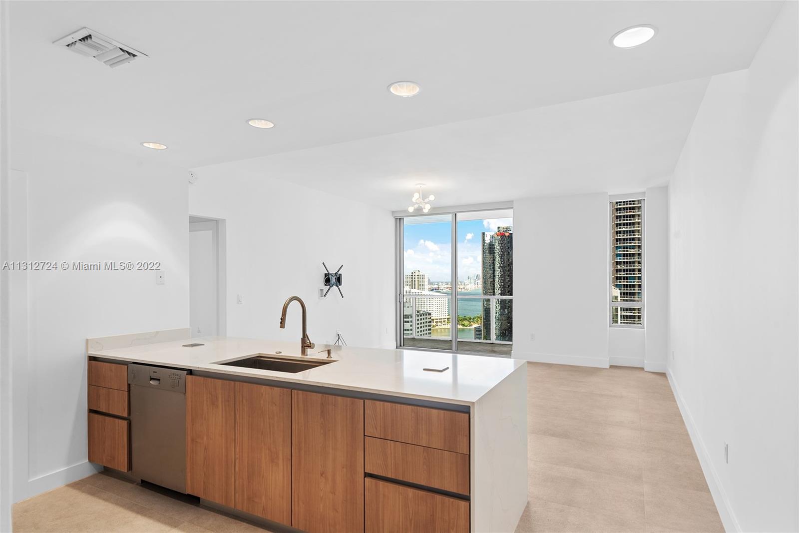 Fully renovated and rarely available corner unit at 1060 Brickell Condominium. Residents of this unit will enjoy spectacular bay and city views from the large wraparound balcony. Fully renovated in 2022 with porcelain flooring, new kitchen cabinetry, extended quartz countertops, remodeled bathroom with terrazzo tile and glass enclosure, new doors, and custom closet. Great layout with large bedroom closet, enclosed laundry area, open kitchen, and lots of light. 1060 Brickell is a well-managed community with amenities including fitness center, sauna, pool, hot tub, wine and cigar room, business center, virtual golf and billiards. In the heart of Brickell with easy access to Brickell City Centre, Mary Brickell Village, metro mover, dining, entertainment and supermarkets.