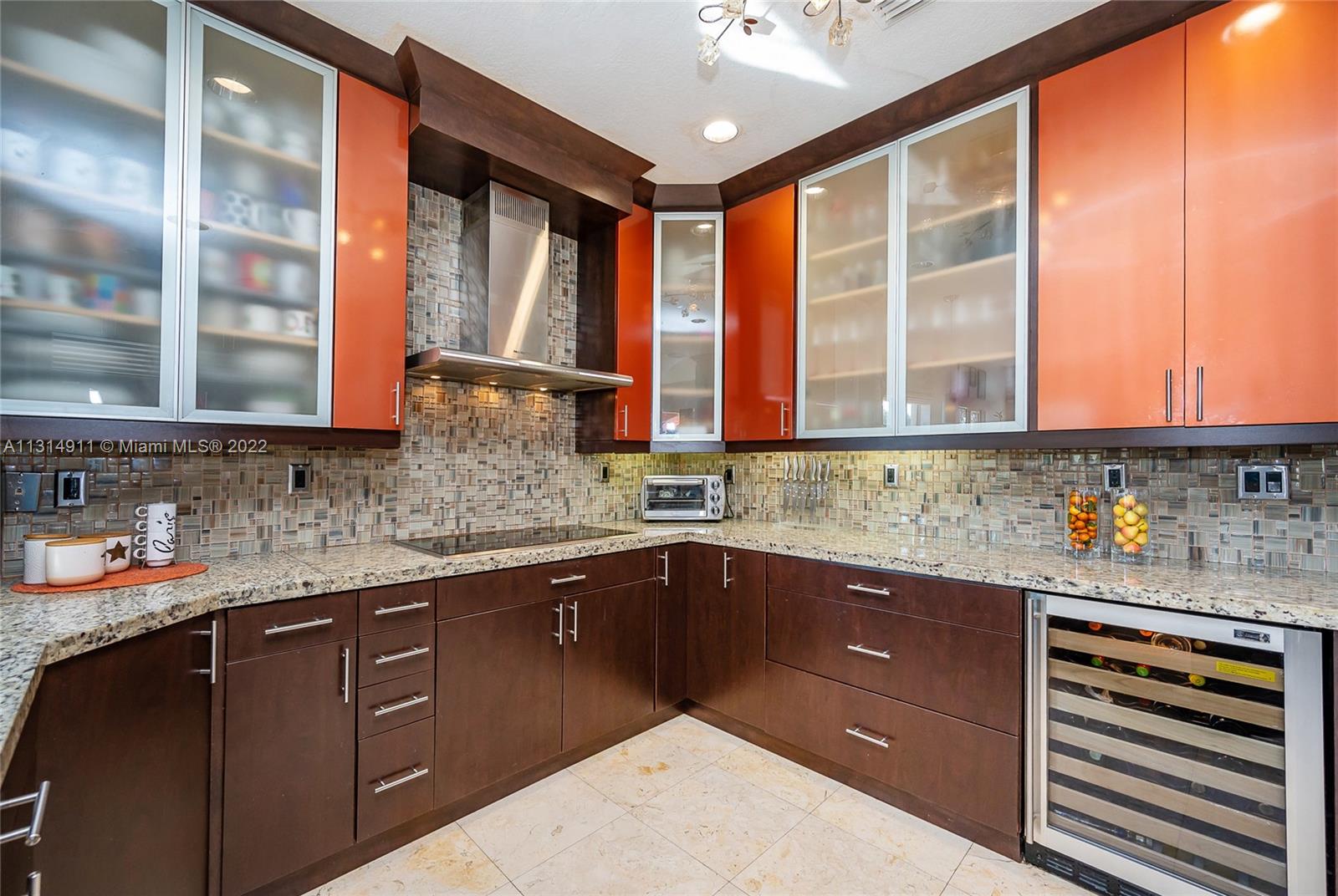 Granite counter, wine cooler, and plenty of cabinet space.