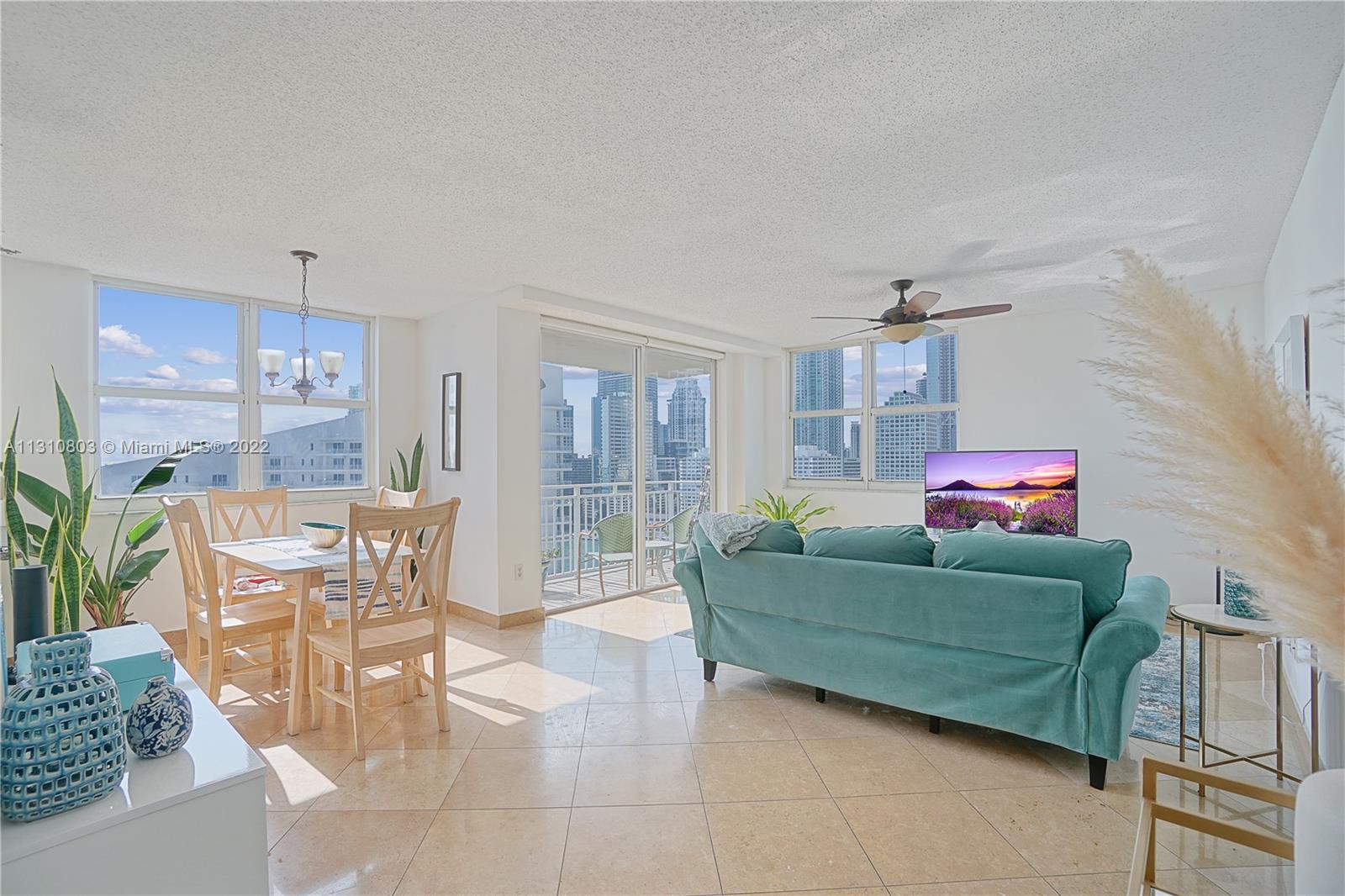 Living room and dining room view from apartment foyer. Light and bright.