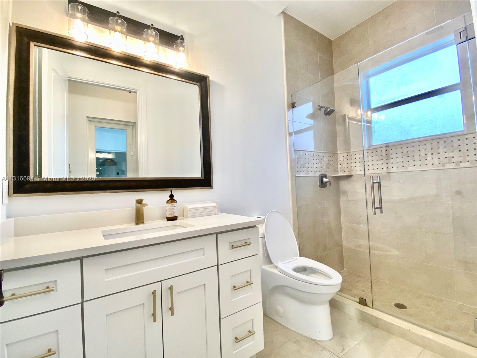 Cabana Bathroom serving the Family Room and Pool Area. 
