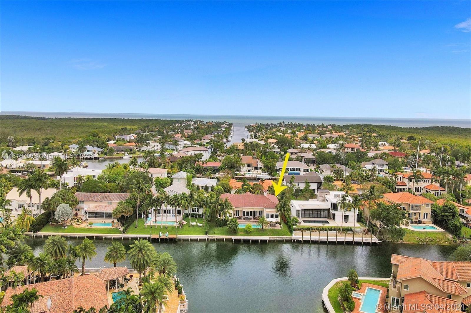 Stunning, split level waterfront mansion located in guard-gated Gables By The Sea, boasts the most picturesque setting for Florida's sunsets. Situated on a unique, T-style, wide section of the waterway with endless water views, the property has 5 bedrooms with master on the first floor. All rooms on the first floor including the bedroom, kitchen, breakfast area, formal dining with large windows, living room with fireplace,& oversized family room ALL HAVE WATER VIEWS AND 15' HIGH CEILINGS. The covered patio with retractable awnings overlooks the swimming pool and the water. There is a separate laundry room with ample cupboards, and the house has 2 x 2 car garages. Gables by the Sea is a treelined, tranquil & serene community located beside Gulliver Prep, a private day school.