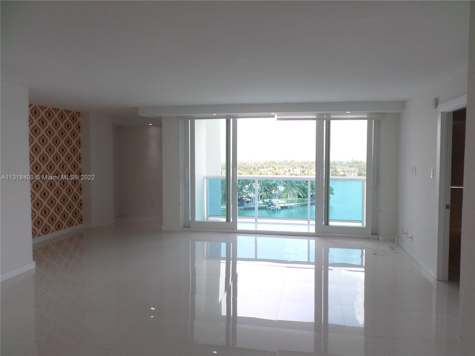 Living room & balcony w/ high impact windows to the balcony facing the bay.