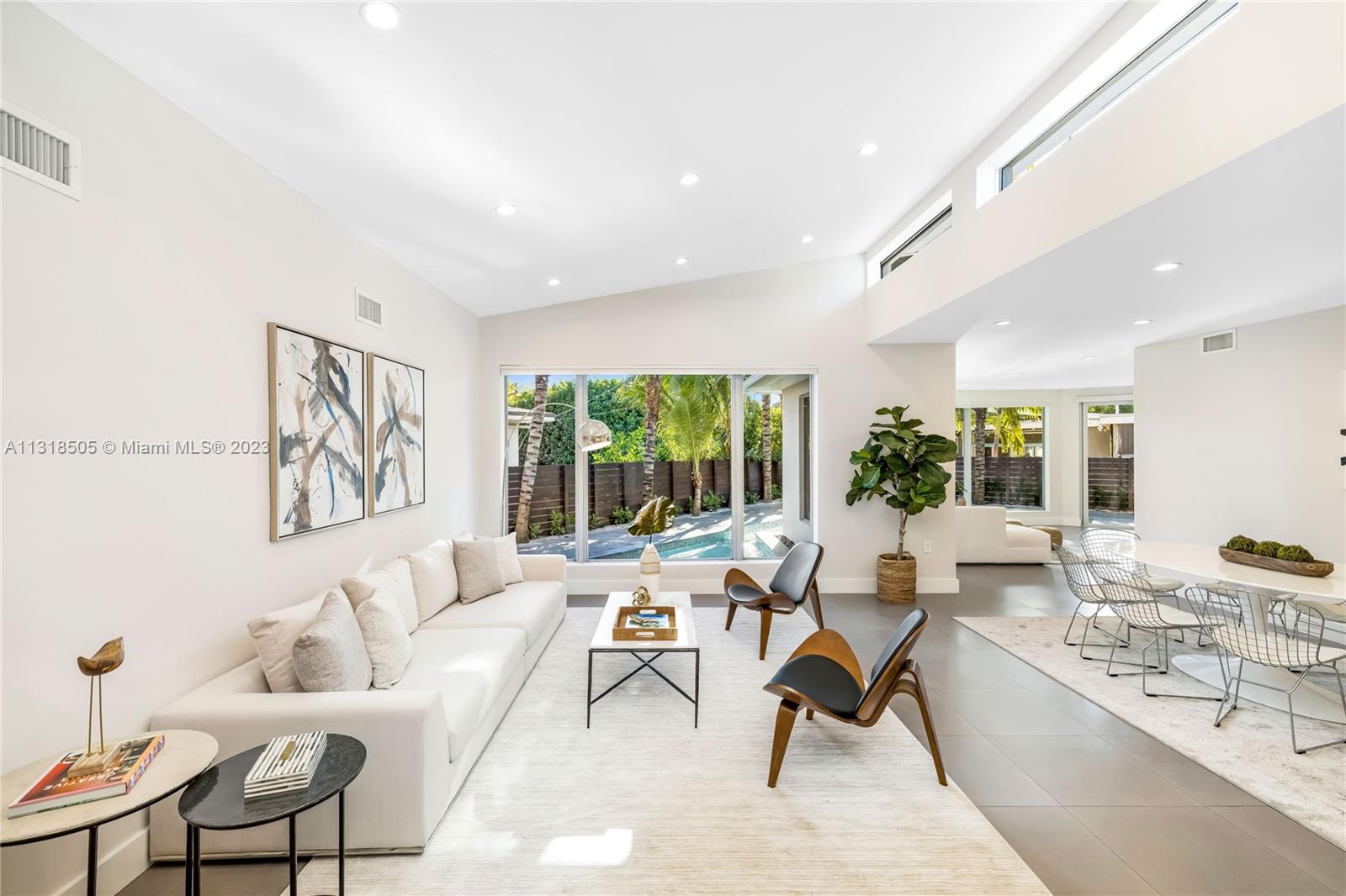 Come and live in the most sought after gated community of Miami Beach.Stunning and unique home with 5 Bedrooms, 4 Bathrooms, 1 Powder Room  with over 3,100 SF home, that was completely renovated! Enjoy 15’ vaulted ceilings, impact windows & doors, an open kitchen and walk-in pantry, 9 ft island, quartz countertops, formal living area, casual family room & views of the unique wrap-around heated pool & deck. Split floor plan w/ primary suite w/ sitting room (easily converted into an office), large walk-in closet, expansive master bathroom w/ separate lux tub & shower. Continuous porcelain tile throughout. This home offers an ideal lifestyle for family and entertainment. Live in this guard-gated island of Normandy Shores Golf Club and enjoy golf, tennis & gorgeous views.