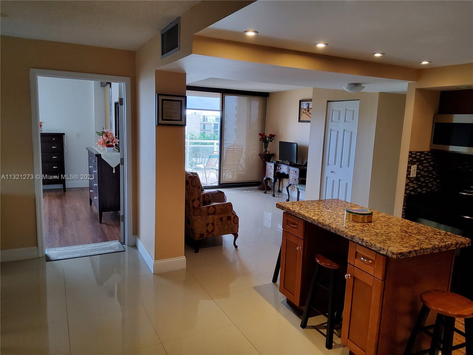 Kitchen looking at guest bedroom and balcony
