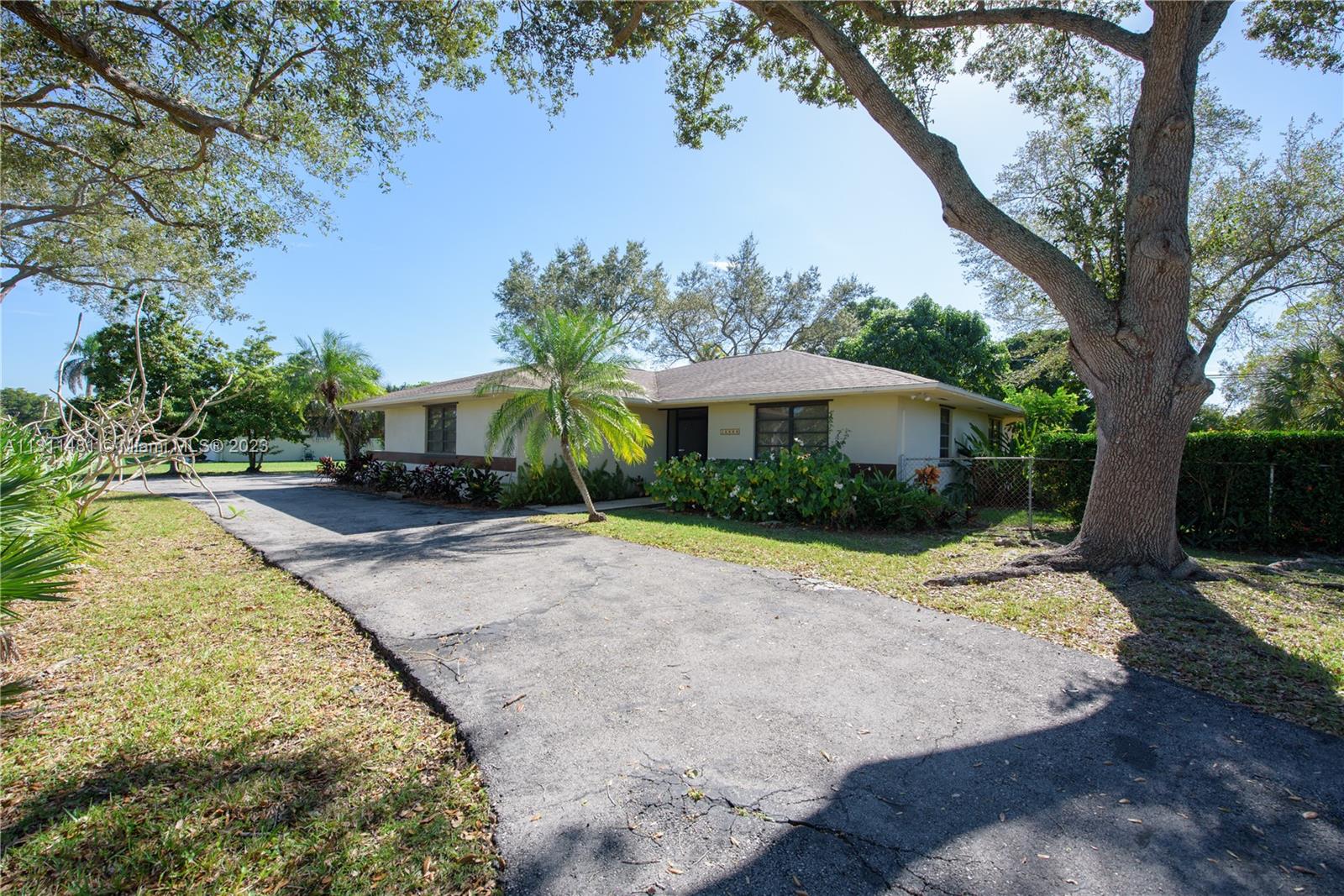 This home has 2 bedrooms and 2 bathrooms and it sits on a 17,892 SQFT lot. This home features a screened in front porch as well as a large covered screened in patio off the back of the house. There is a circular driveway and a 2 car garage. This home has a great room, great for entertaining and spending time with loved ones. The kitchen is very spacious and has a large walk-in pantry as well as a double sink. The great room and the kitchen both have sliding glass doors that lead out to the back patio. The back yard is fenced with a double gate. There is starfruit, mango, loquat, sapodilla, and oak trees. Also, there is an irrigation system with a pump.