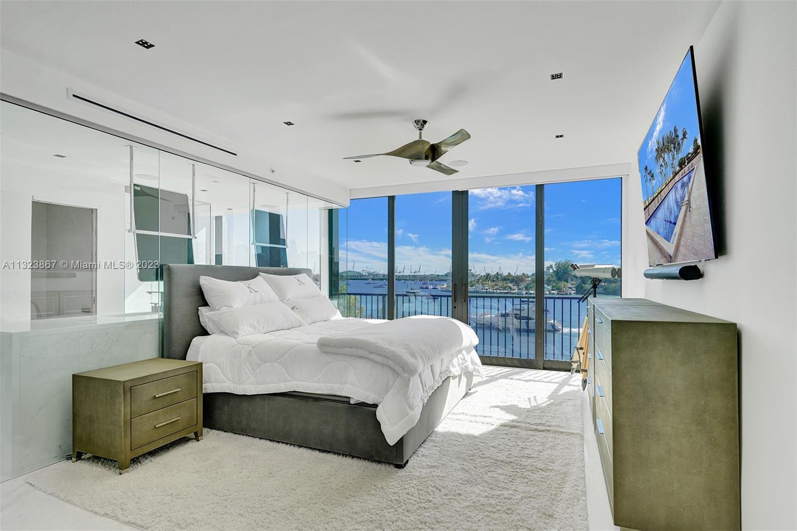 Primary bedroom with views of water, yachts, cruise ships and downtown Miami skyline