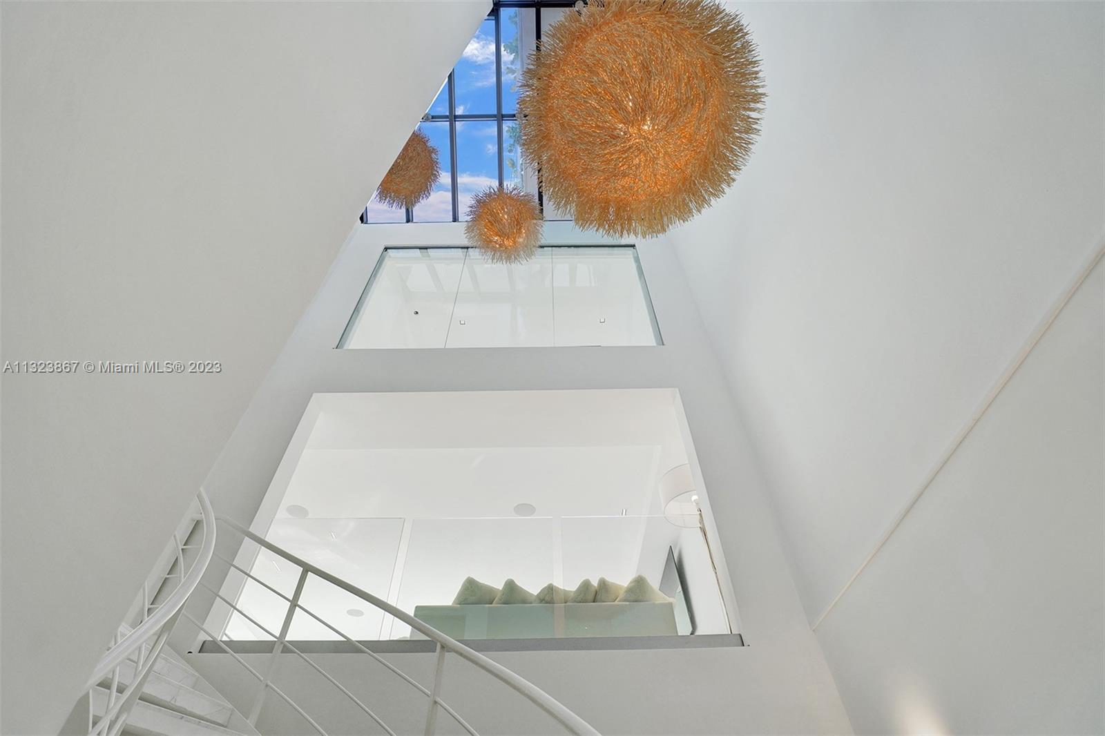 35ft high foyer with natural light from ground floor entrance to roof. 3ft square White carrera marble. museum reveal walls