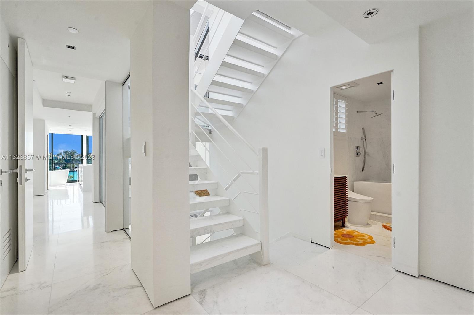 35ft high foyer with natural light from ground floor entrance to roof. 3ft square White carrera marble. museum reveal walls