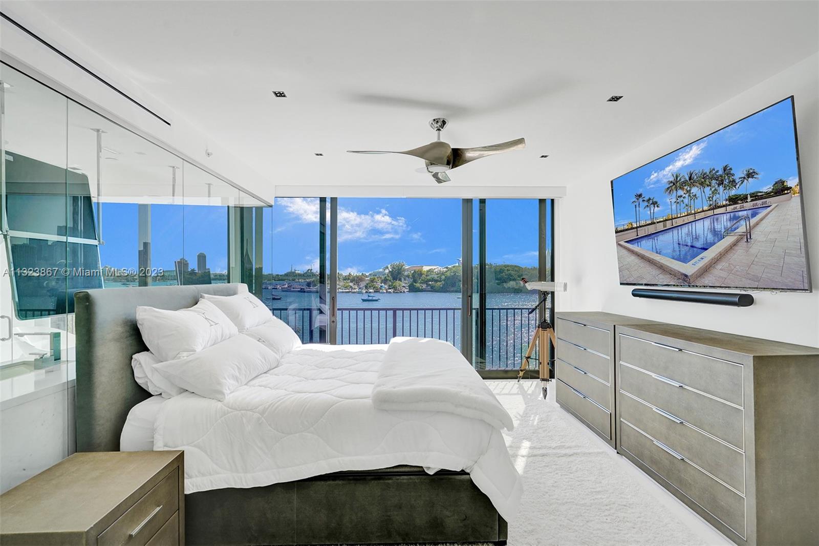 Primary bedroom with views of water, yachts, cruise ships and downtown Miami skyline