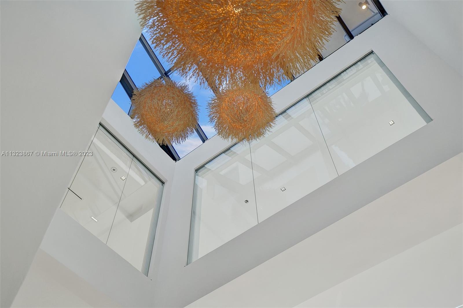 35ft high foyer with natural light from ground floor entrance to roof. 3ft square White carrera marble. museum reveal walls