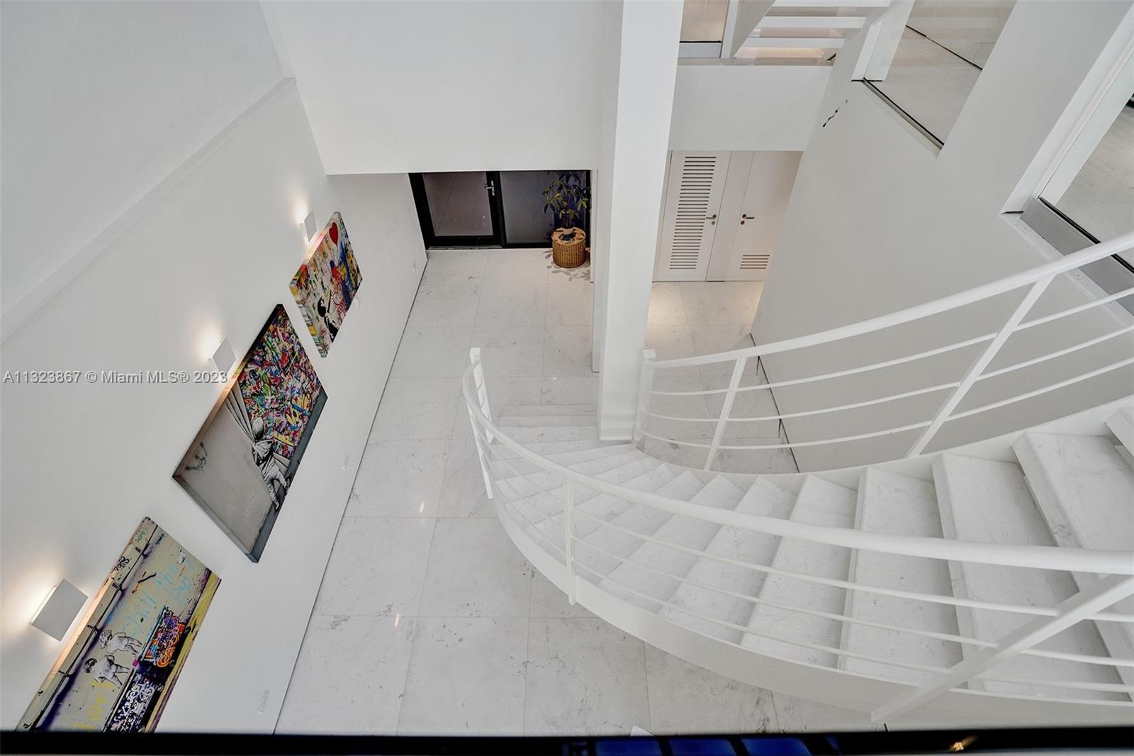 F35ft high foyer with natural light from ground floor entrance to roof. 3ft square White carrera marble. museum reveal walls