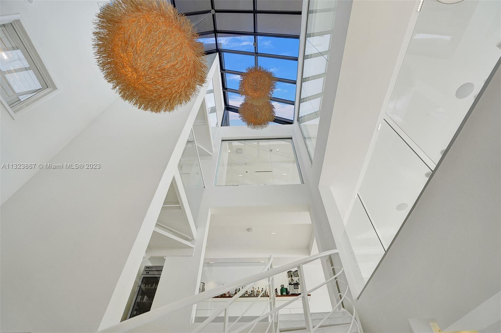 35ft high foyer with natural light from ground floor entrance to roof. 3ft square White carrera marble. museum reveal walls