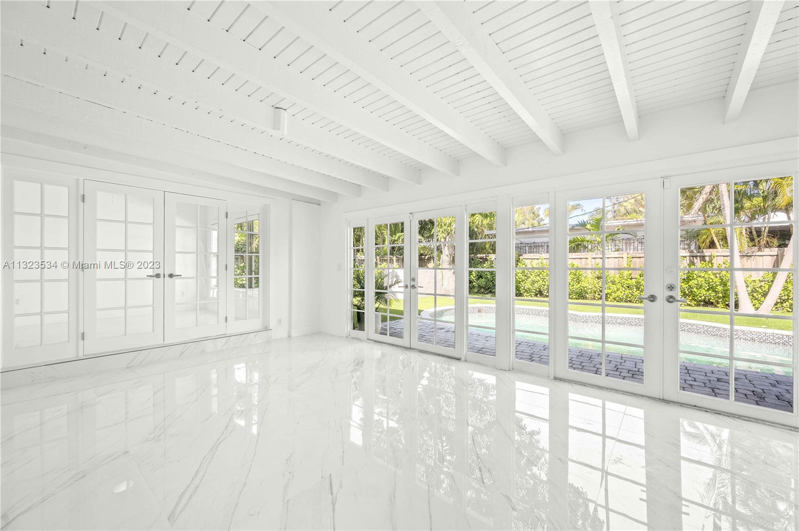 The sunroom leading to the pool and 4th bedroom