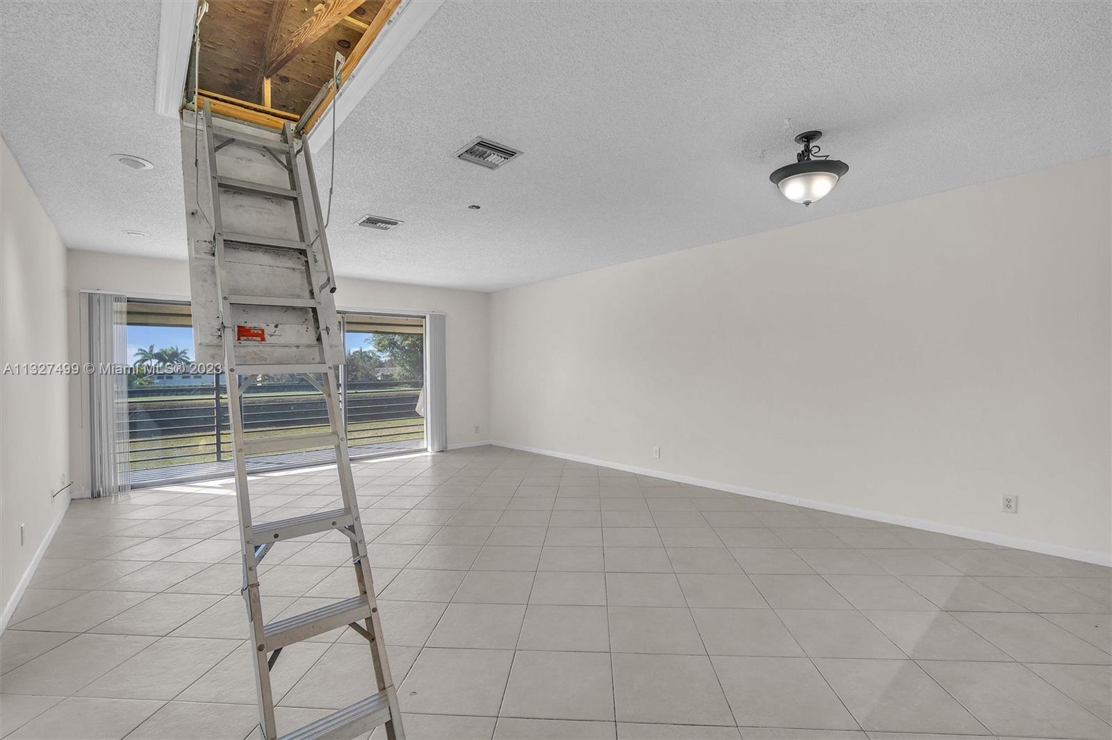 Staircase to huge lit attic storage