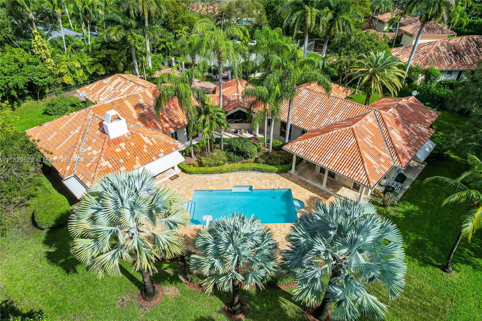 Private North Pinecrest one-story gated estate on a near-full acre located on a quiet cul-de-sac. As you enter this elegant, light-filled home with south-west exposure you are greeted by idyllic garden views from the foyer that divides the living areas from the bedrooms. Formal living and dining rooms lead to the oversized family room and updated kitchen that features an oversized island, top of the line appliances, breakfast area. Volume ceilings, Italian wood doors. Outdoor entertainment spaces include built-in bbq, pool/spa, large yard with many exotic trees. 2-car garage has been converted to a gym. Superb public and private schools nearby. This is the ideal family home in one of Miami's most upscale neighborhoods.