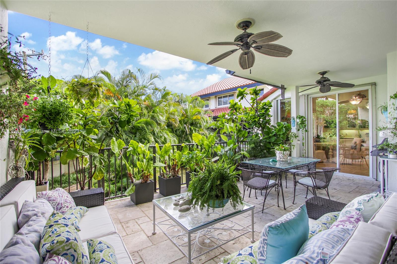 Another beautiful space, great for entertaining! Sliding doors open up from the living room and kitchen onto the large terrace overlooking the lush landscaping and ponds below. Room for outdoor seating, dining table, and barbeque.
