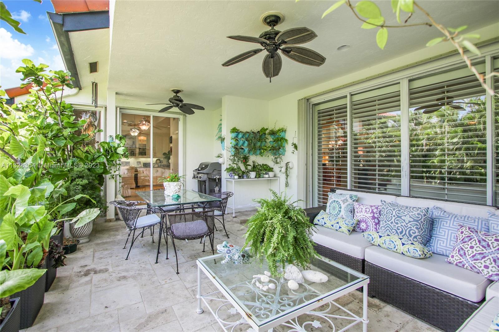 Covered terrace with garden/water landscape views, lights and fans- another place to entertain! Great barbeque location, easy to cook dinner and serve on terrace or kitchen