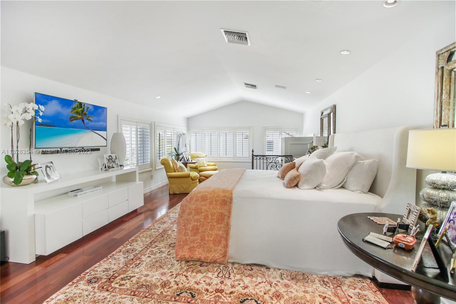 Oversized 1,100 sq. ft. primary suite has a sitting area as well as well-appointed home office, custom Plantation shutters, high ceilings